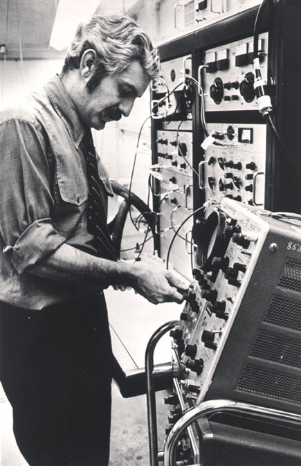 Dr. Damadian looking at an instrument called an oscilloscope